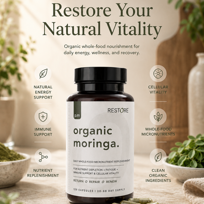 Supplement bottle labeled 'organic moringa' with promotional text on a wooden surface.