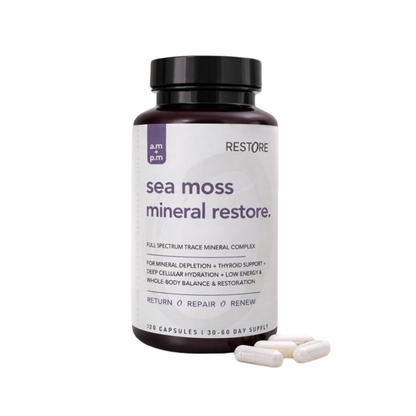 Sea moss mineral restore supplement bottle with capsules on a white background